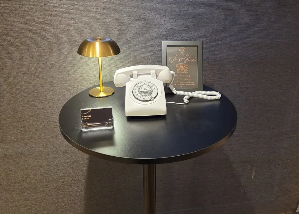Milas Events Audio Guest Book setup with a white telephone, gold lamp and instructional sign