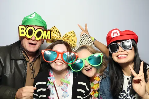 Four guests wearing party hats with a BOOM prop at a corporate event at Hotel Steyne Manly