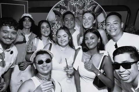 Black and white group portrait with photo booth props at a corporate event with Prestige Harbour Cruises