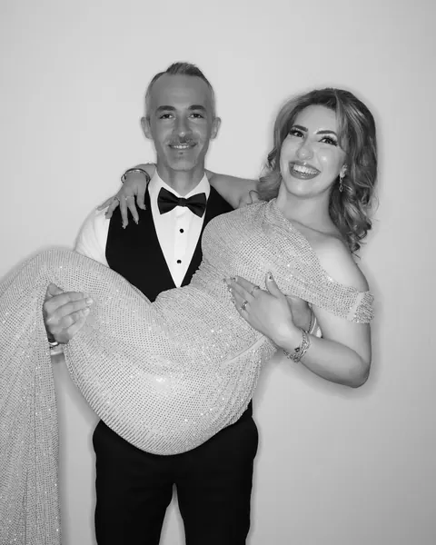 Guest holding their partner in a black and white Gold Booth portrait